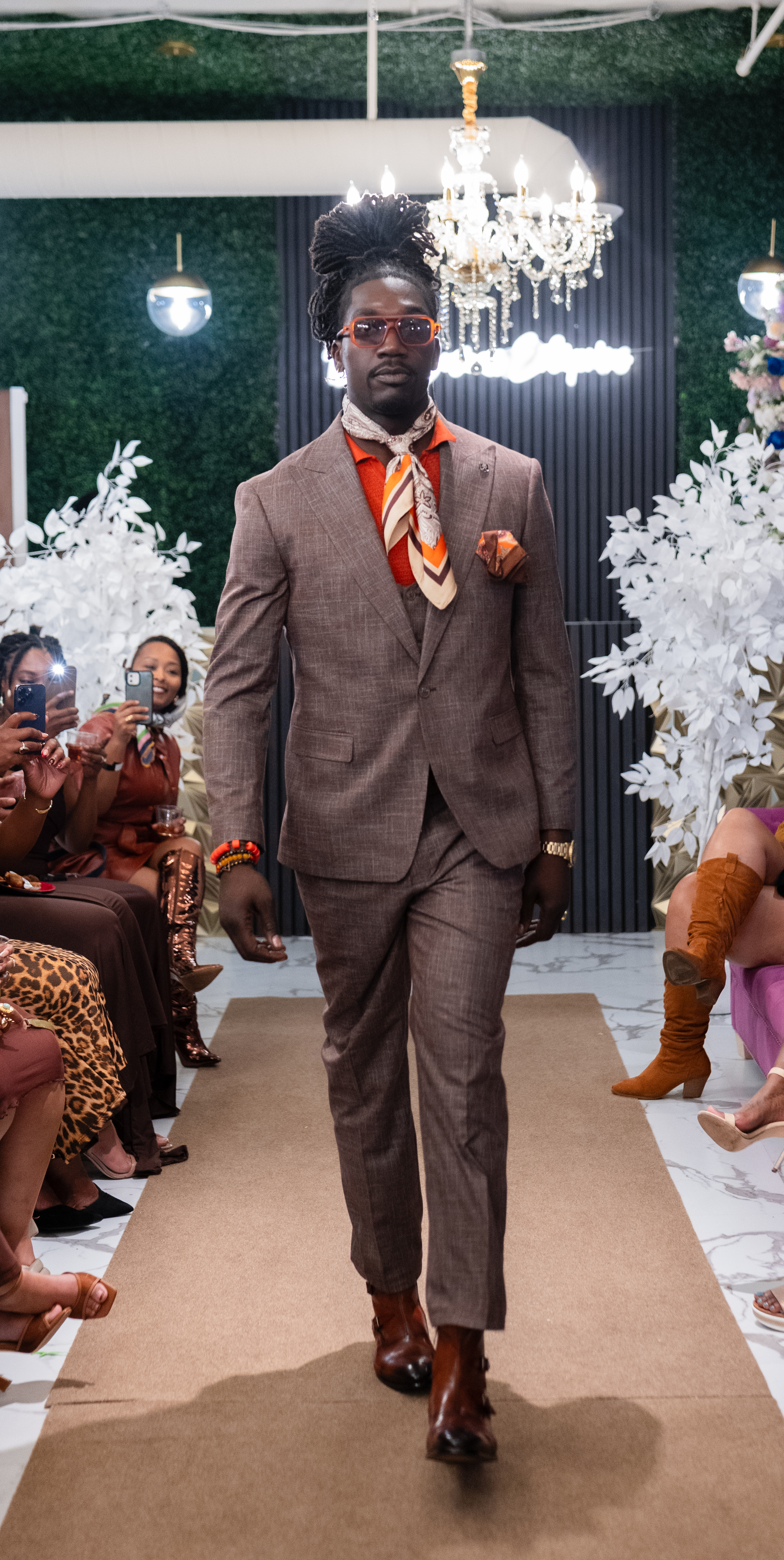 A model in elevated brown attire on the 2025 runway